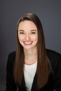 Dr. Alexandria Jernberg - Pacific Clear Vision Eugene Professional headshot of Dr. Alexandria Jernberg wearing a black blazer and white blouse, smiling warmly against a neutral gray background. - Pacific Clear Vision Eugene