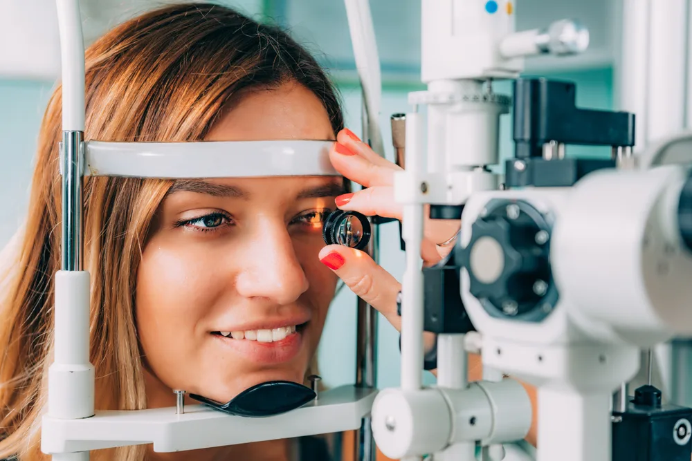 Eye exam before LASIK Woman having a comprehensive eye exam with a slit lamp before LASIK surgery